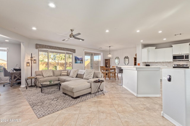 living room featuring ceiling fan and light tile patterned floors