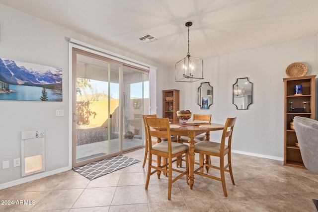 tiled dining space with a chandelier