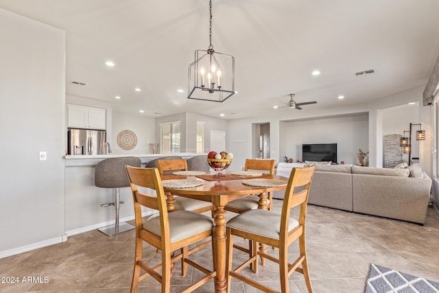 dining room featuring ceiling fan with notable chandelier