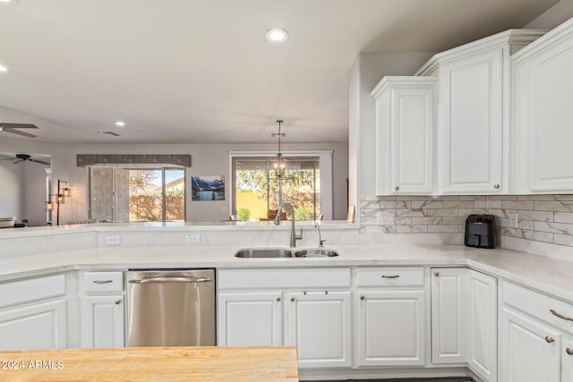 kitchen featuring sink, stainless steel dishwasher, ceiling fan, tasteful backsplash, and white cabinetry