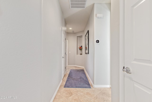 hall featuring light tile patterned floors