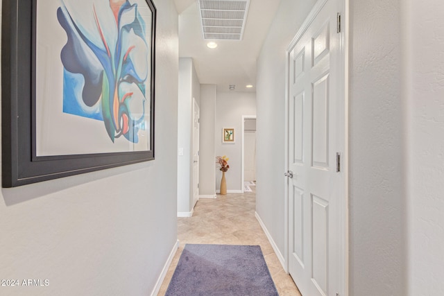 hall with light tile patterned floors