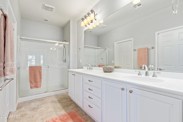 bathroom featuring tile patterned flooring, vanity, and walk in shower