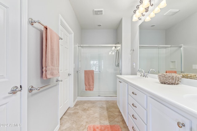 bathroom with tile patterned flooring, vanity, and an enclosed shower