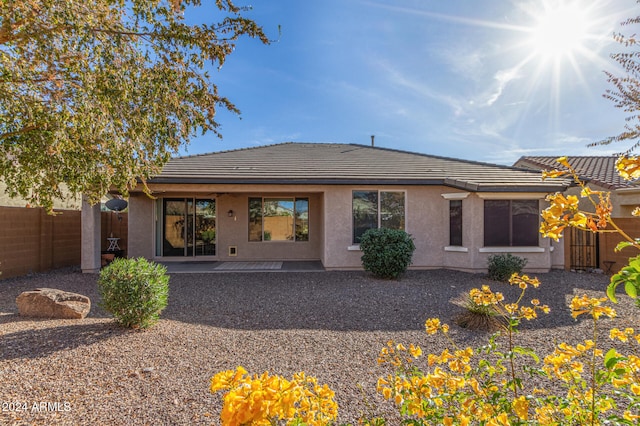 back of property with a patio