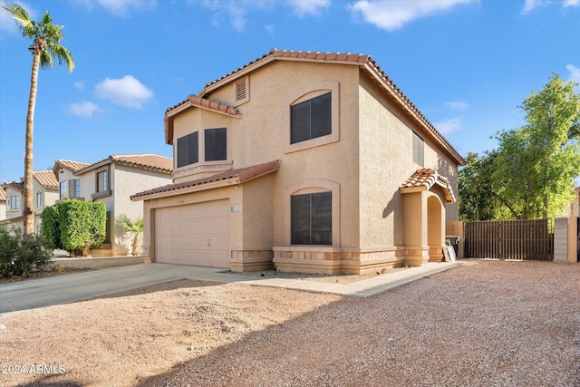 mediterranean / spanish-style home featuring a garage