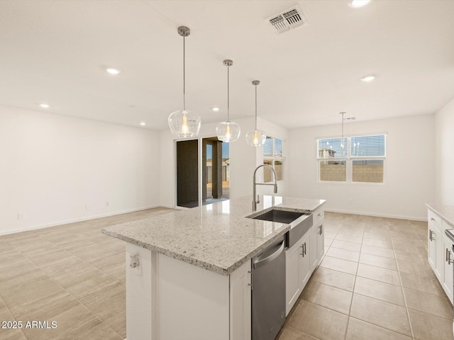 kitchen featuring a kitchen island with sink, dishwasher, hanging light fixtures, and sink