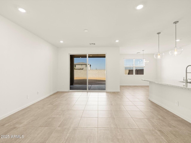 unfurnished room with sink and light tile patterned flooring