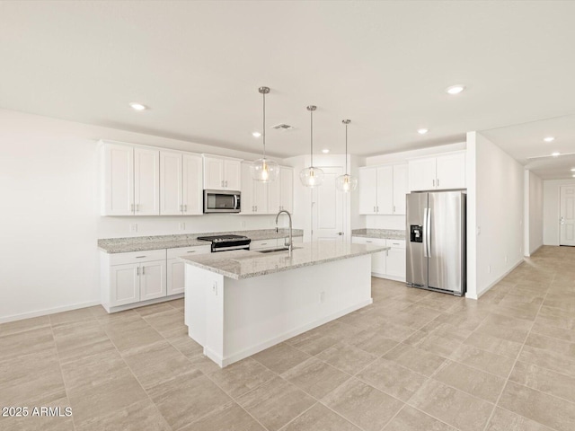 kitchen with sink, white cabinetry, stainless steel appliances, and an island with sink