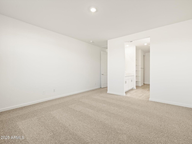 spare room with light colored carpet