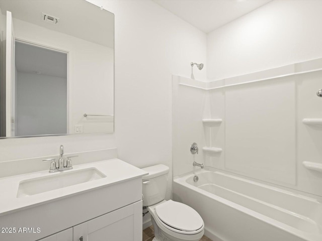 full bathroom featuring washtub / shower combination, toilet, and vanity