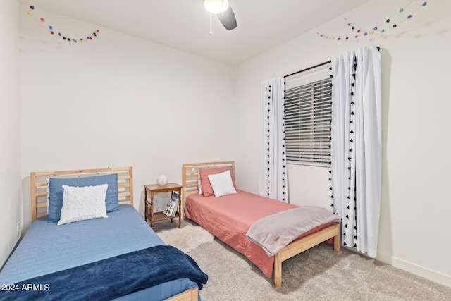 bedroom featuring light carpet and ceiling fan