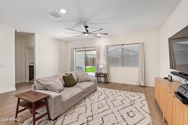 living room with light hardwood / wood-style floors and ceiling fan