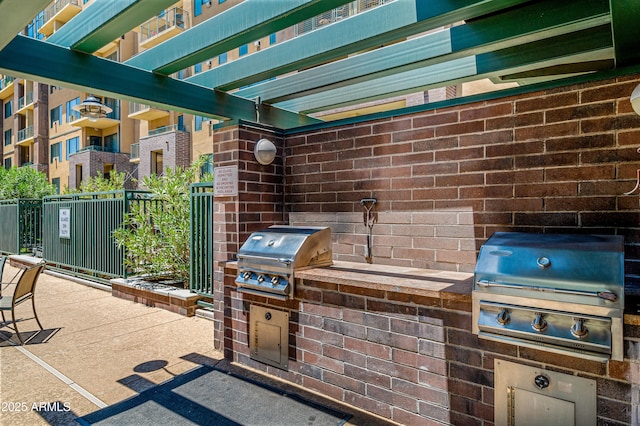 view of patio / terrace with a pergola, grilling area, and an outdoor kitchen