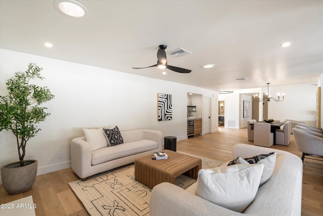 living room featuring wine cooler, visible vents, and light wood-style flooring