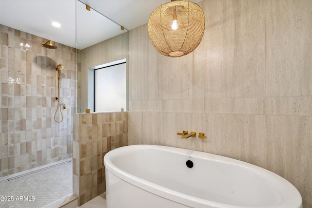 full bathroom with a freestanding bath, tile walls, and walk in shower