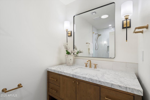 full bathroom featuring visible vents, a shower, and vanity