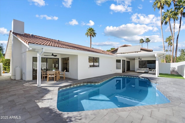 rear view of property with ceiling fan, a tile roof, fence, and a patio