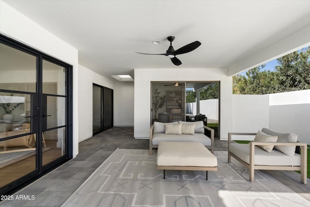 view of patio with ceiling fan, an outdoor living space, and fence