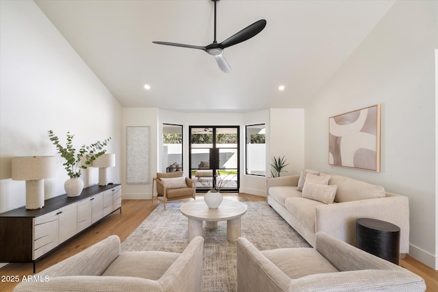 living area featuring lofted ceiling, ceiling fan, light wood finished floors, and recessed lighting