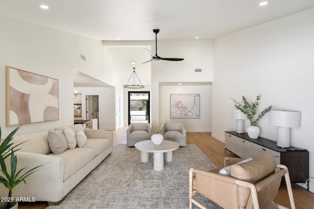 living room featuring a chandelier, recessed lighting, and wood finished floors