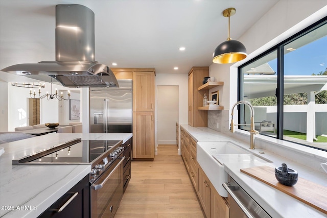 kitchen featuring open shelves, light wood-style floors, a sink, island range hood, and high quality appliances