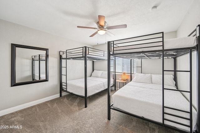 bedroom with a ceiling fan, baseboards, and carpet