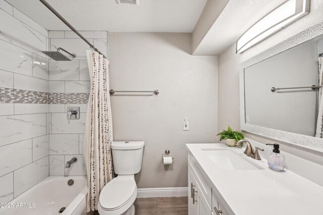 bathroom with shower / tub combo with curtain, vanity, toilet, baseboards, and visible vents