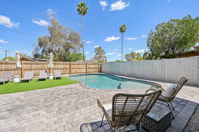 view of swimming pool with a fenced backyard, a fenced in pool, and a patio area