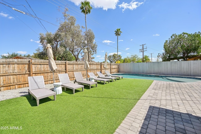 view of yard featuring a fenced backyard, a fenced in pool, and a patio area