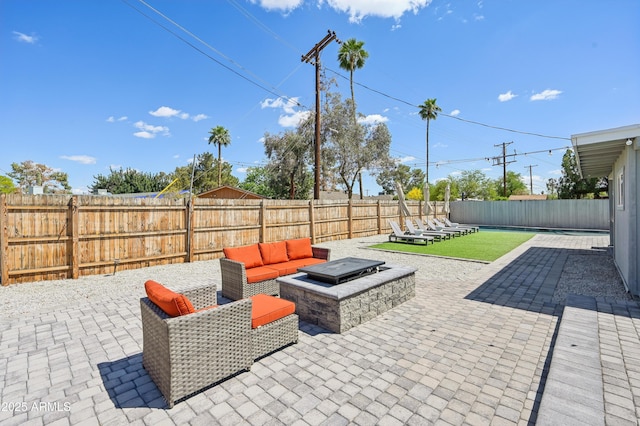 view of patio / terrace with a fenced backyard and an outdoor living space with a fire pit