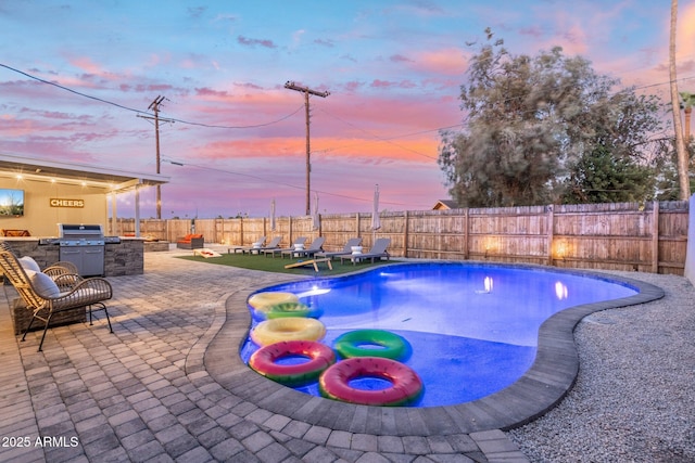 pool at dusk featuring a fenced in pool, a fenced backyard, a patio area, and grilling area