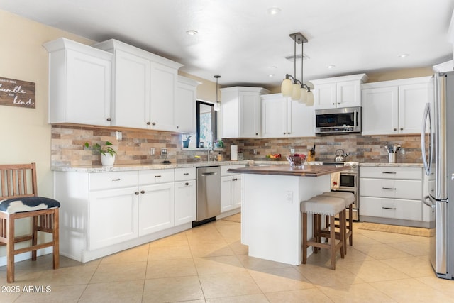 12212 N 66th St, Scottsdale, AZ 85254 - kitchen with stainless steel appliances, white cabinetry, and recessed lighting
