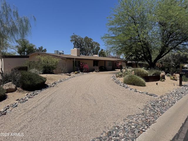 12212 N 66th St, Scottsdale, AZ 85254 - view of front facade with a chimney and driveway
