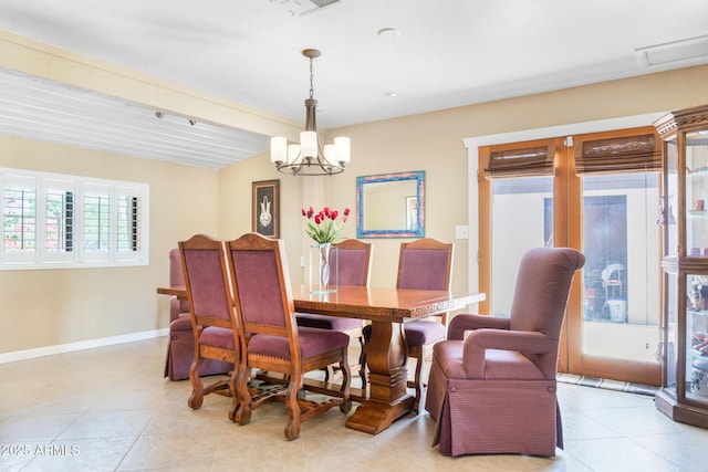 12212 N 66th St, Scottsdale, AZ 85254 - dining area with beamed ceiling, a chandelier, and light tile patterned floors