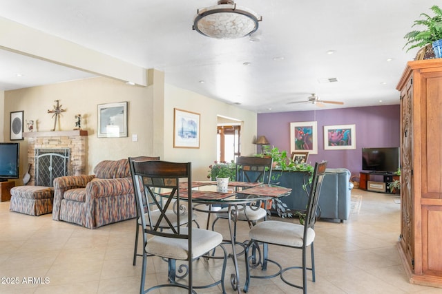 12212 N 66th St, Scottsdale, AZ 85254 - dining area featuring light tile patterned flooring, a ceiling fan, a fireplace, and recessed lighting