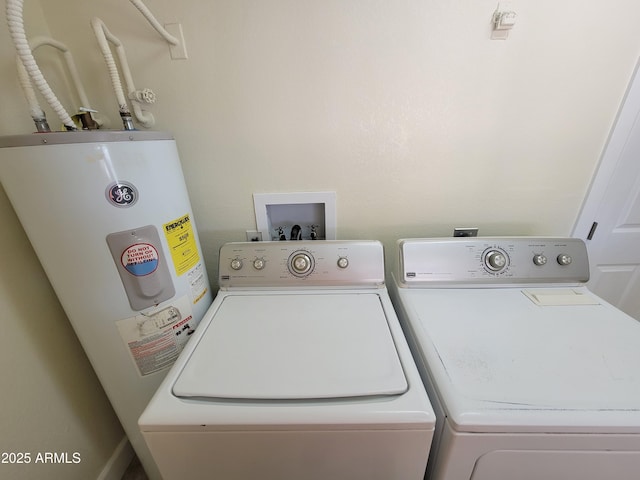 clothes washing area featuring separate washer and dryer and electric water heater