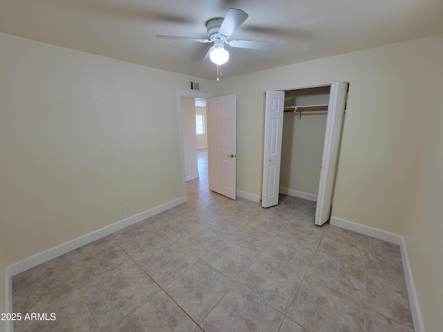 unfurnished bedroom featuring baseboards, visible vents, a closet, ceiling fan, and light tile patterned floors