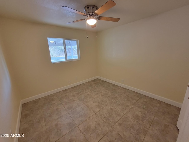 empty room featuring a ceiling fan, baseboards, and light tile patterned floors