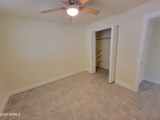 unfurnished bedroom with ceiling fan, baseboards, a closet, and light tile patterned floors