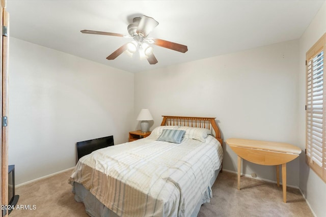 bedroom featuring light colored carpet and ceiling fan