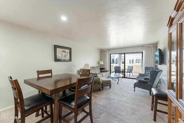 dining space with light colored carpet