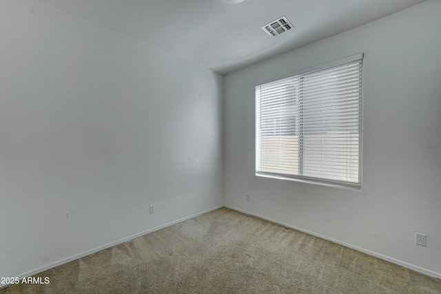 carpeted spare room featuring plenty of natural light