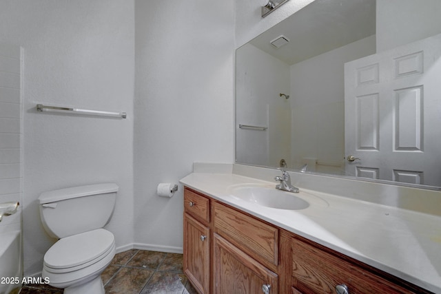 bathroom featuring toilet, vanity, and a bath