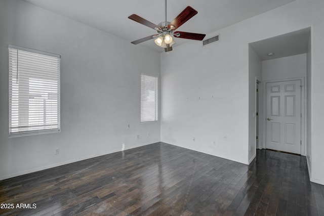 empty room featuring ceiling fan and dark hardwood / wood-style flooring