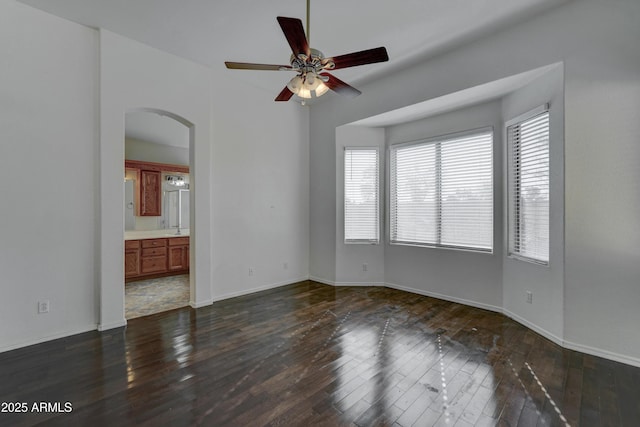 spare room featuring sink, ceiling fan, and dark hardwood / wood-style floors