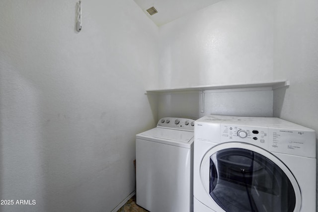 laundry room featuring washing machine and clothes dryer