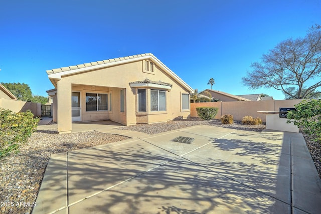 rear view of house with a patio