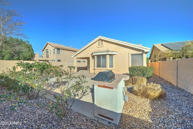 view of front of property featuring a patio area and area for grilling