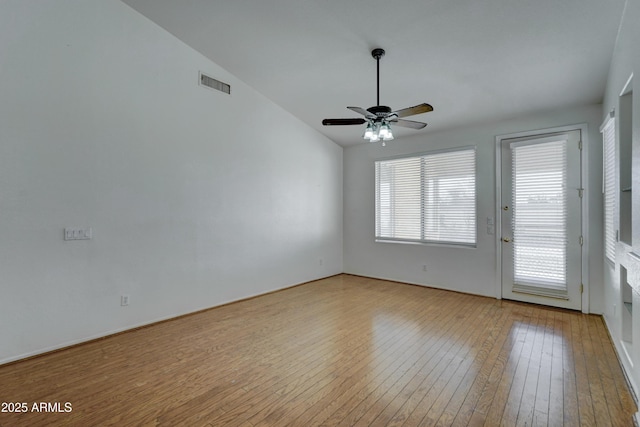 spare room with ceiling fan, light wood-type flooring, and lofted ceiling